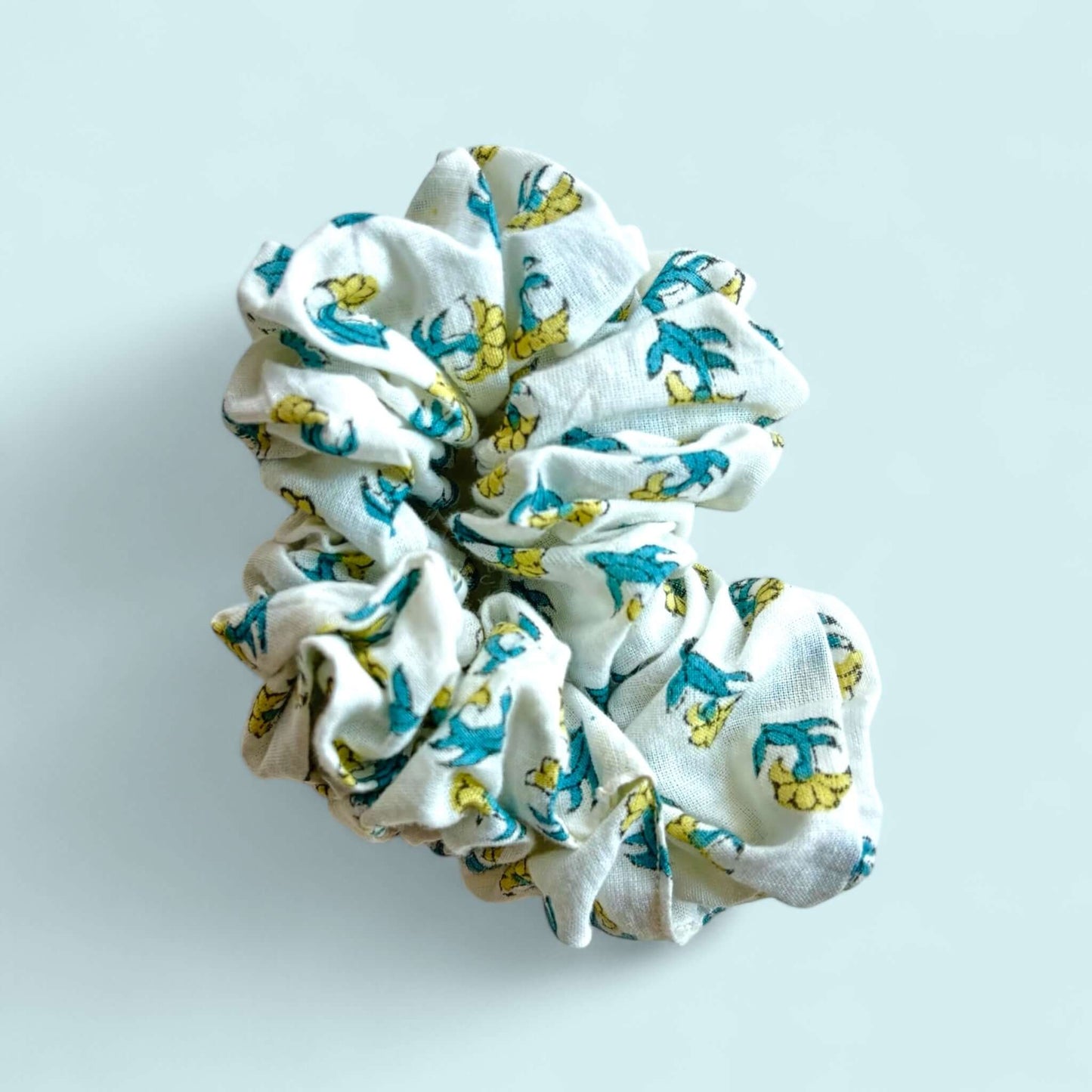 Handmade scrunchie, blockprinting, white background with small yellow flowers