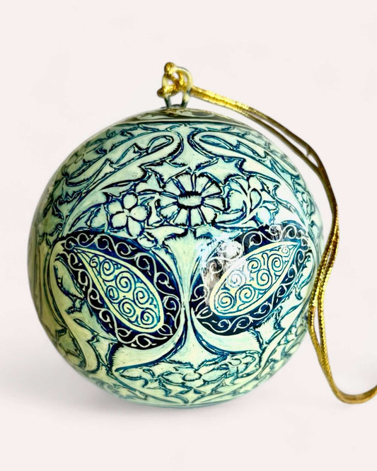 Hand-painted papier maché Christmas ornament with mint and blue paisley floral design, crafted in Srinagar, Kashmir, 8 cm diameter.