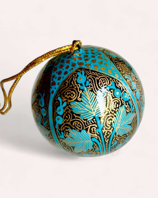 Gold and blue papier maché Christmas ornament with black and gold hand-painted designs, crafted in Kashmir.