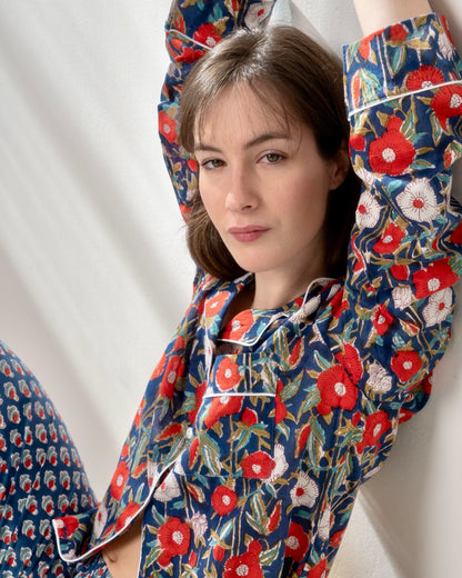 Elegant blue pajama top with large floral pattern and mother-of-pearl buttons.