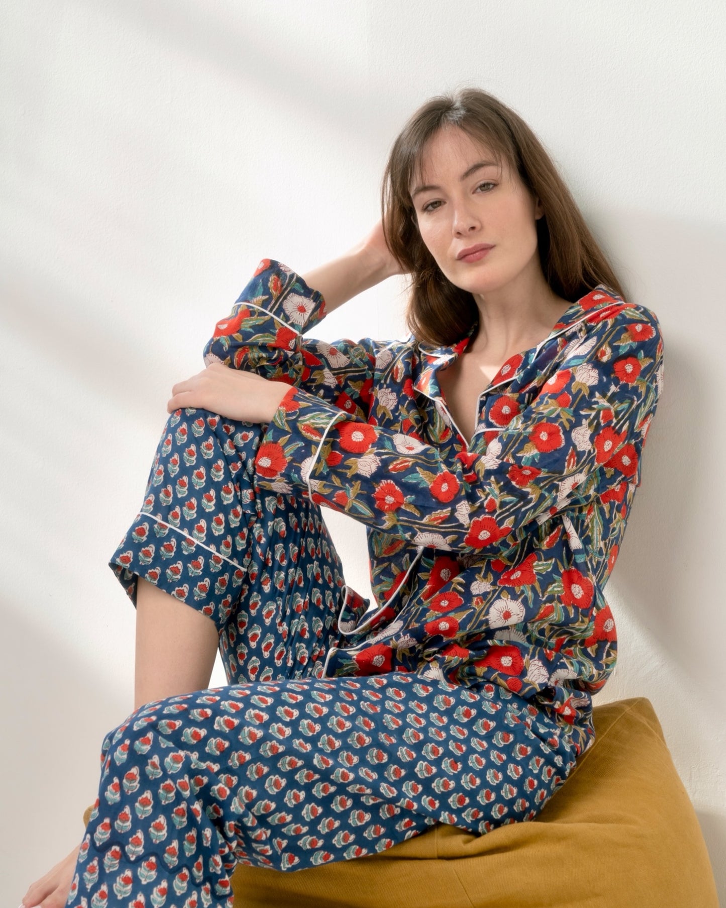 Women's blue cotton pajama set with red and white floral block print.